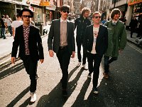 Kaiser Chiefs  The band walking on a street.